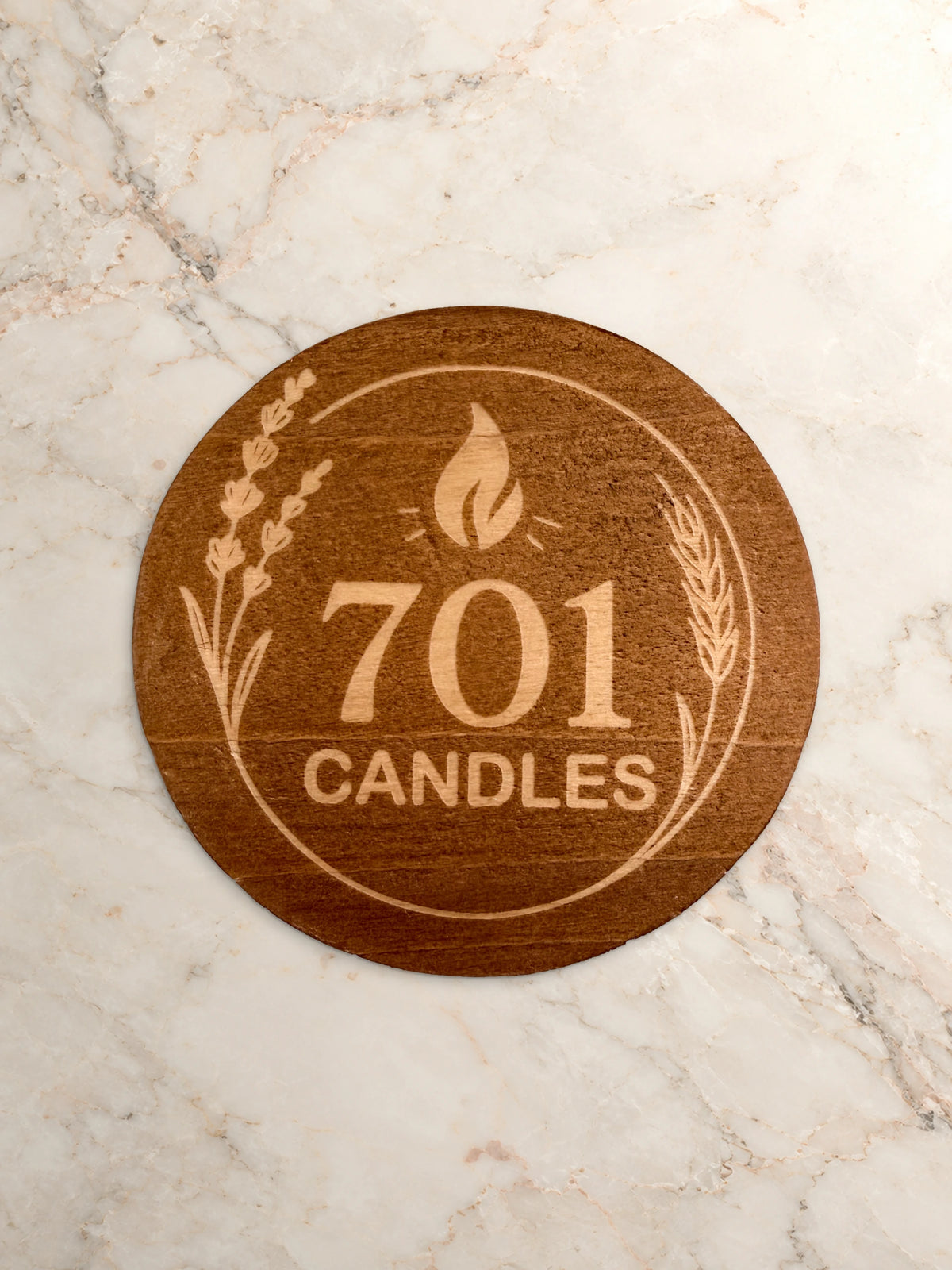 701 Candles wooden lid with engraved logo and prairie details on warm marble