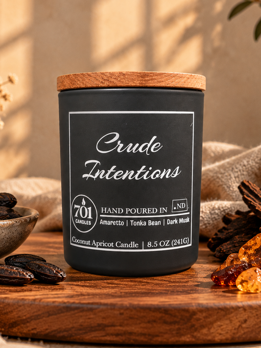 Crude Intentions candle in a matte-black ceramic vessel with an engraved wooden lid.