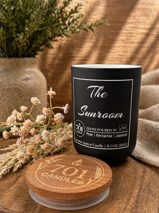 The Sunroom hand-poured coconut apricot candle in matte black tumbler with wooden lid